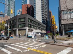 A street corner in Brooklyn showing a building with "The Fresh Grocer - Coming Soon" signage. The storefront appears to be under development at what will become the chain's first NYC location on Fulton Street. The image shows the exterior of the future grocery store in an urban setting.