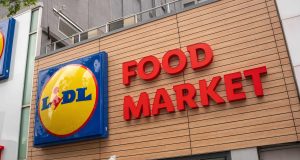 Storefront signage for LIDL Food Market on Fulton Street. Sign below says "Now Open"